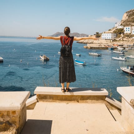 Ragazza che guarda il mare in Sicilia